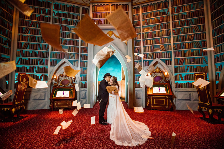 Shellie, AKA "The Serial Bride," and her husband pose for pictures in the Disneyland Resort.