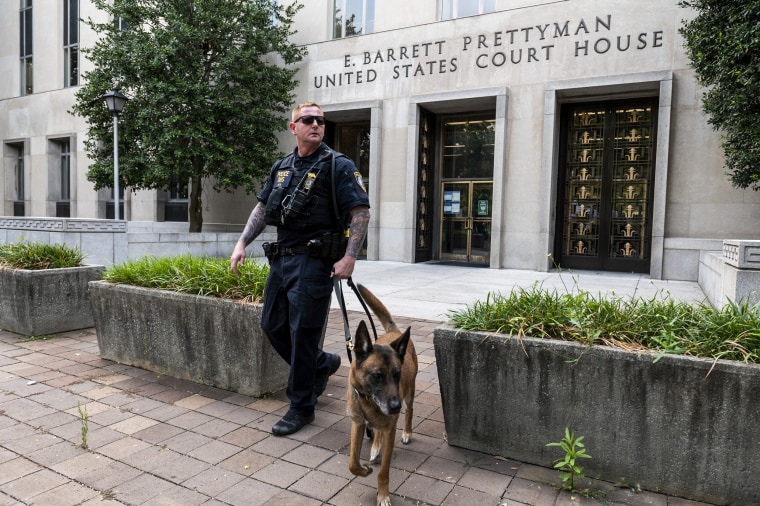 A  Homeland Security canine unit sweeps one of the entrances to the E. Barrett Prettyman United States Courthouse in Washington on Aug. 3, 2023.