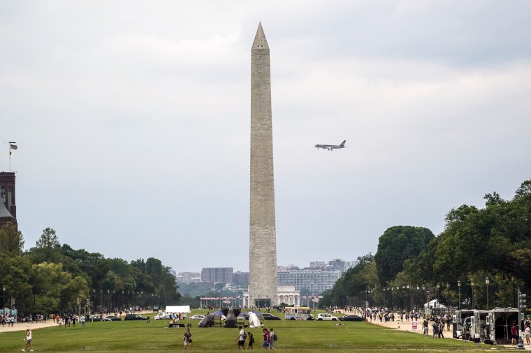 Image: Former President Donald Trump's airplane flies behind the Washington Monument as it makes its final approach into Reagan National Airport, on Aug. 3, 2023, in Washington.