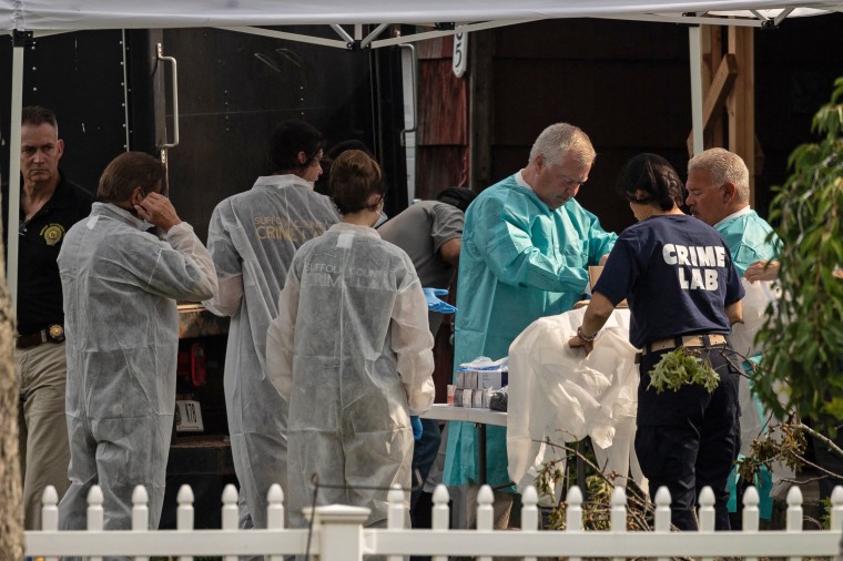 Crime laboratory officers prepare to search the home of Gilgo Beach murders suspect Rex Heuermann in Massapequa Park, New York, on July 18, 2023.