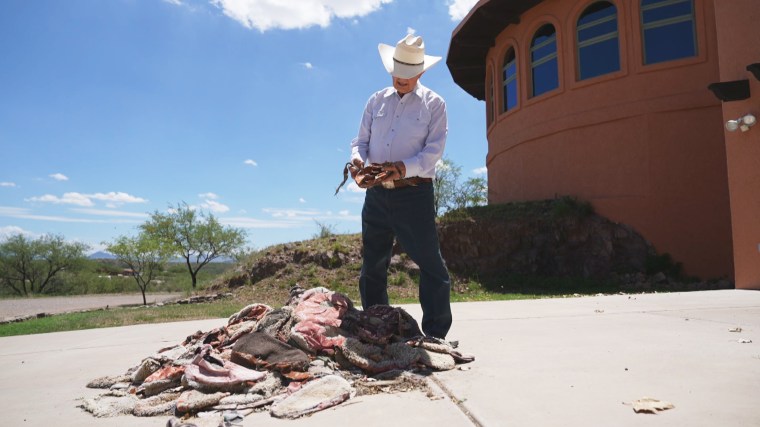 Arizona rancher Jim Chilton looks over a pile of carpet shoes, which migrants often use to avoid detection on foot, that he’s found on his property.