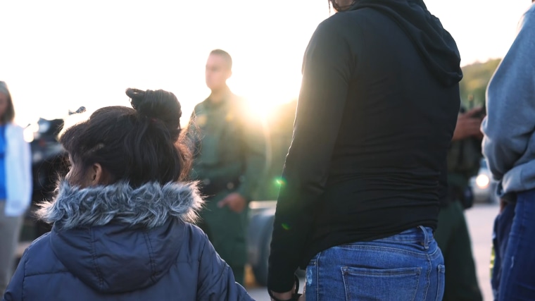 A group of migrants are apprehended by Border Patrol shortly before sunrise in Nogales, Ariz.