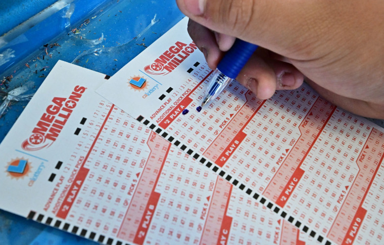 A person selects numbers on a Mega Millions ticket in Los Angeles, California, on Aug. 4, 2023. 