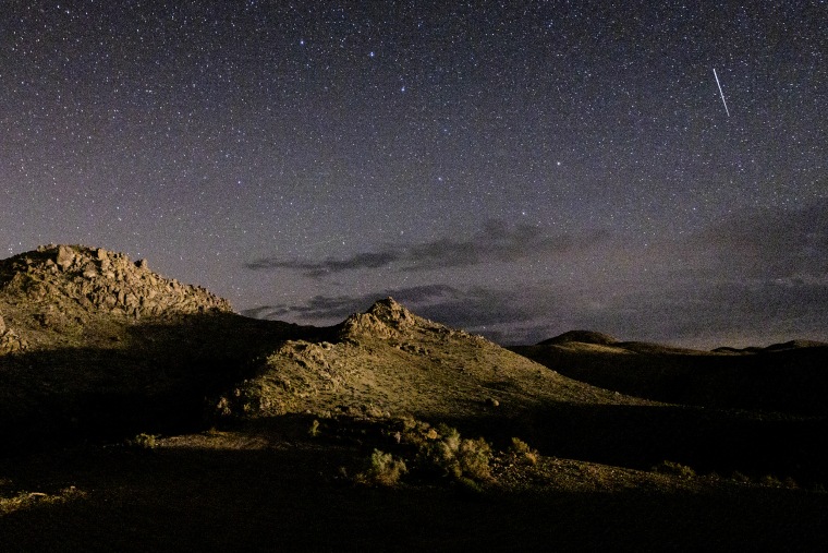 A meteor streaks across the sky over the Alabama Hills during the annual Perseid meteor shower near Lone Pine, Calif.  on August 20, 2022