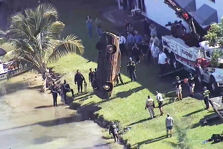 Authorities remove a vehicle from Doral Lake in Miami, on Aug. 8, 2023.