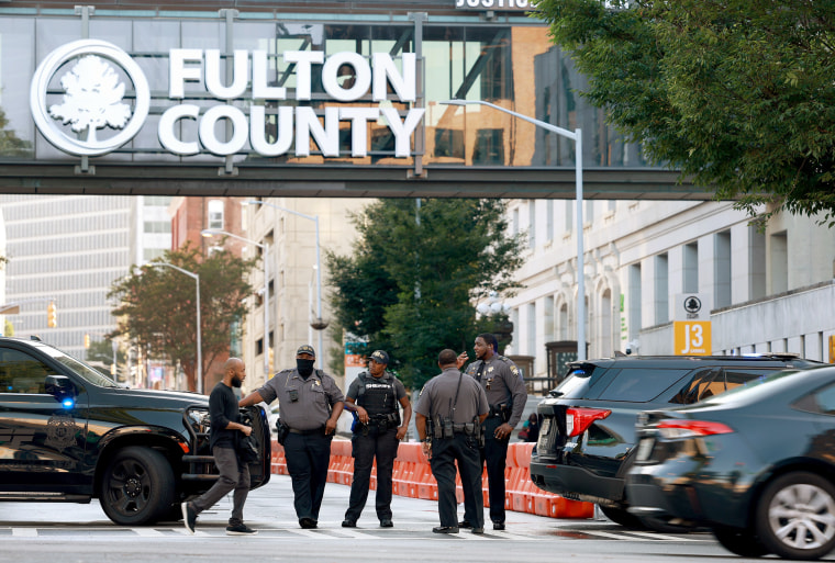 Fulton County Sheriff officers block off a street in front of the Fulton County Courthouse in Atlanta on Aug, 7, 2023.