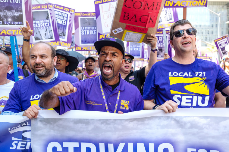 Striking city employees march in the streets around city hall on Tuesday, chanting “we are the union” and “fighting for justice.” on Aug. 8, 2023.