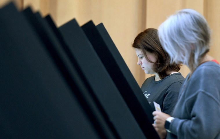 Juliya Brown, left, joins her mother, Alanna Brown, to vote in Ohio's special election in Plain Township on Aug. 8, 2023.
