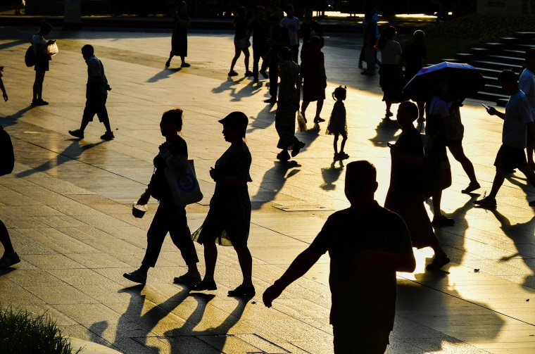 People walk in Chongqing, China, on July 10, 2023.