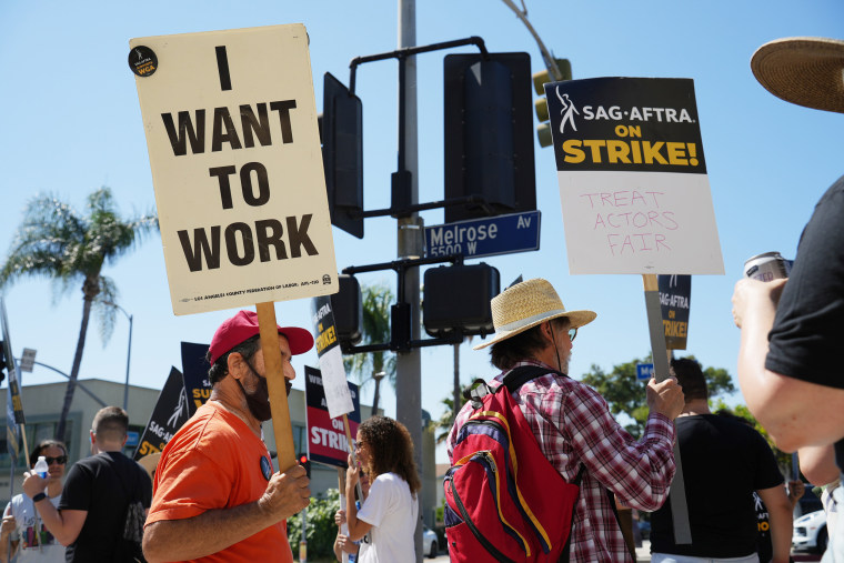 Members and supporters of SAG-AFTRA and WGA walk the picket line at Paramount Studios
