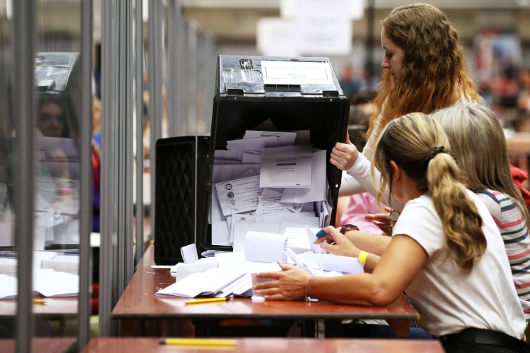 Ballots are emptied from a ballot box for counting at the count centre in Wakefield, in Northern England
