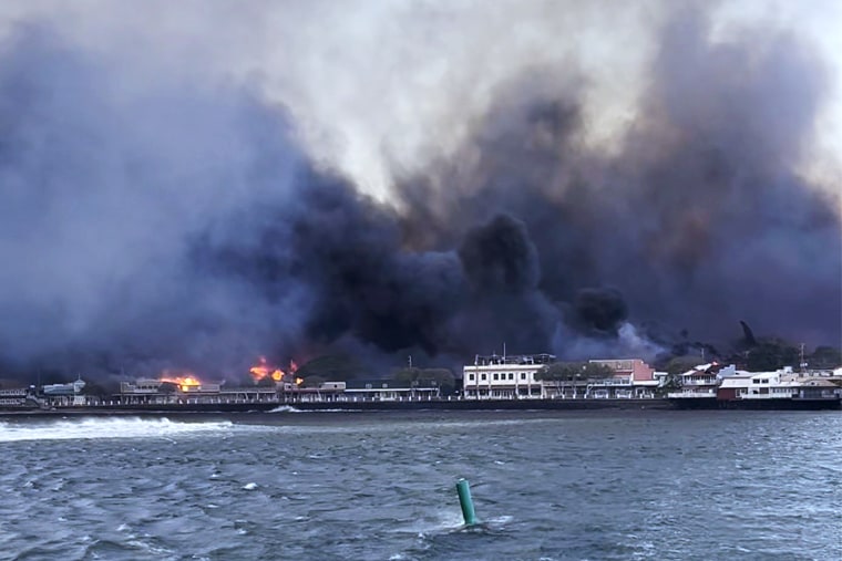 In this photo provided by Brantin Stevens smoke fill the air from wild fires at Lahaina harbor on Tuesday, Aug. 8, 2023 in Hawaii. Fire was widespread in Lahaina Town, including on Front Street, a popular shopping and dining area, County of Maui spokesperson Mahina Martin said by phone early Wednesday. Traffic has been very heavy as people try to evacuate the area, and officials asked people who weren’t in an evacuation area to shelter in place to avoid adding to the traffic, she said.