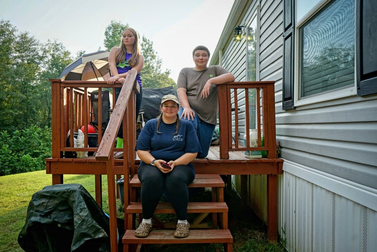 Becky Brown with her two children at her home in Red Banks, Miss.       