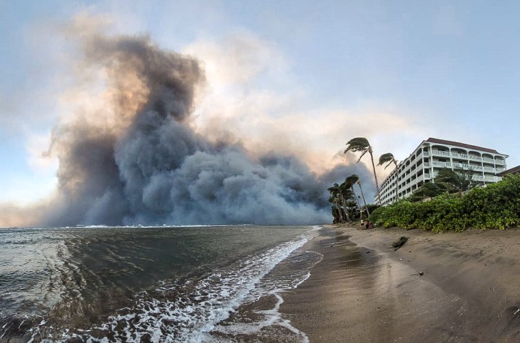 Smoke billows near Lahaina as wildfires driven by high winds destroy a large part of the historic town of Lahaina, Hawaii, on Aug. 9, 2023.