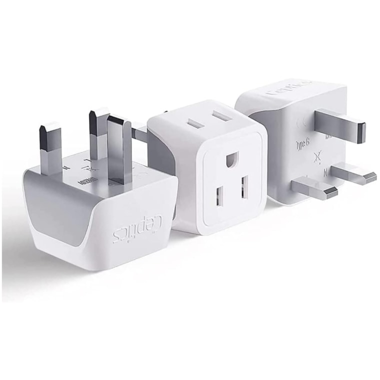 A U.K. to U.S. plug adapter, shown sitting on three different sides
