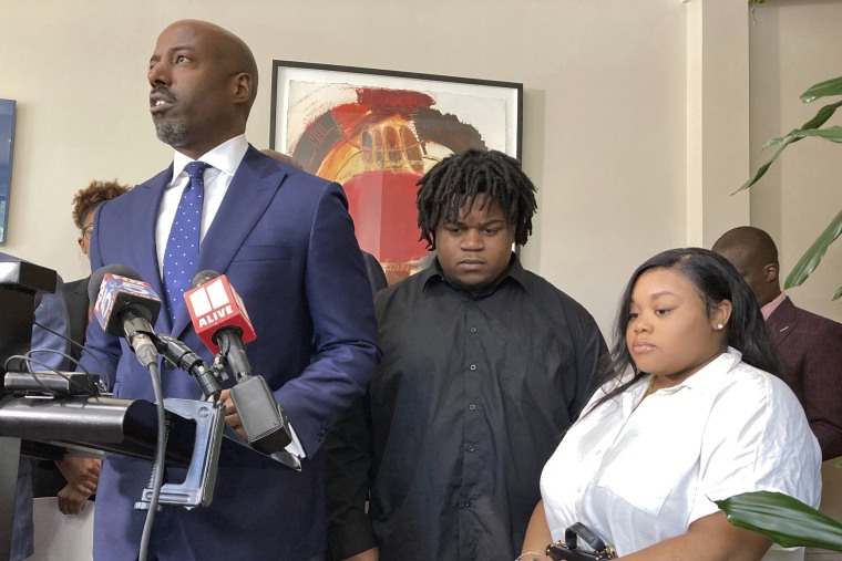 Attorney Cory Lynch, left, Treveon Isaiah Taylor, Sr.,and Jessica Ross speak during a news conference