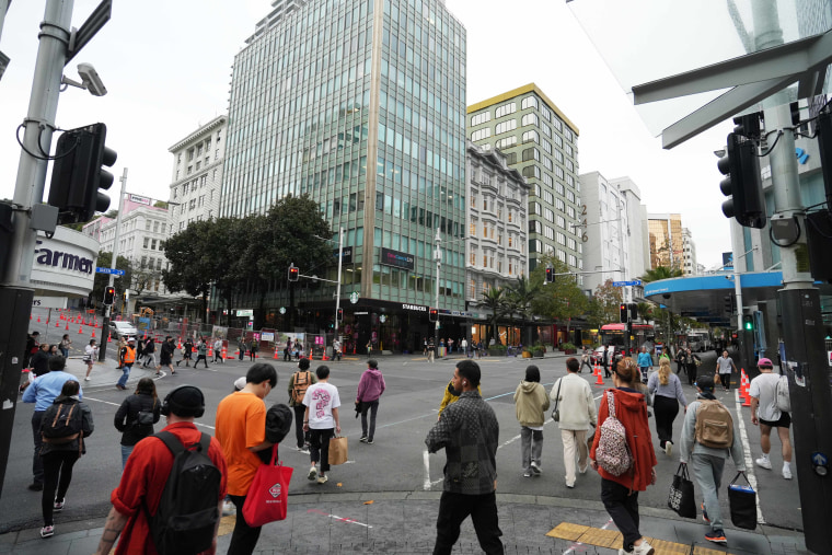 People cross a street in central Auckland. New Zealand, a liberal democracy that is increasingly multicultural, is grappling with how to guarantee Indigenous rights without excluding others. 