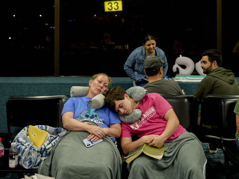 People waiting for departing flights at Kahului Airport on the Hawaiian island of Maui, where at least three wildfires have been raging, in Kahului on Wednesday, Aug. 9, 2023.