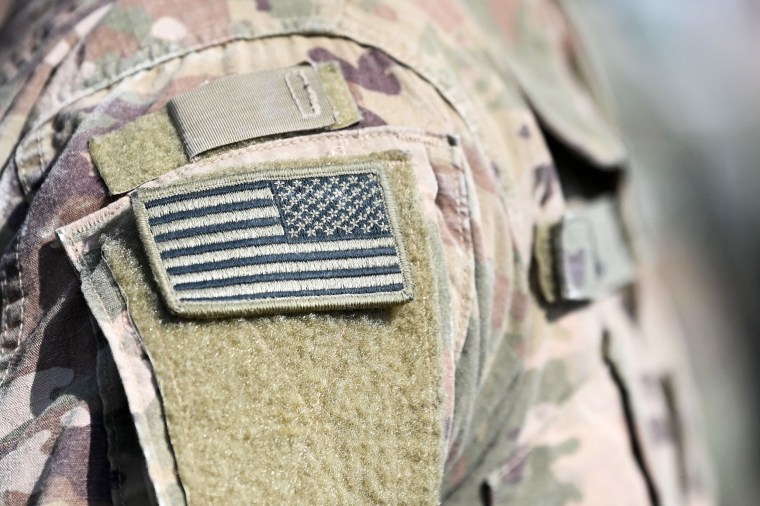 A soldier of the US army wears the country's flag on his uniform during the 'Dynamic Front 22', the US Army led NATO and Partner integrated annual artillery exercise in Europe, in Grafenwoehr, near Eschenbach, southern Germany, on July 20, 2022. - The 'Dynamic Front 22' exercise, led by 56th Artillery Command, is the premier US led NATO and Partner integrated artillery exercise in Europe and includes more than 3000 participants from 19 nations. Allied artillery and supporting units practice integrating joint fires and test interoperability in a multi-national enviroment until 24 July, 2022.