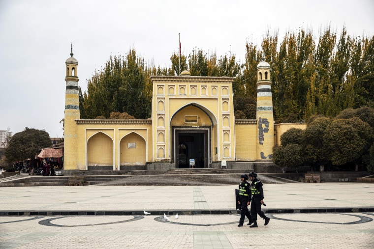 Police officers walk past the Id Kah Mosque in Kashgar, Xinjiang autonomous region, China, on Nov. 8, 2018.
