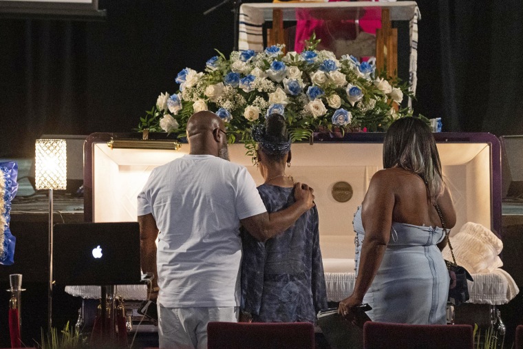 O'Shae Sibley's family gather by the casket during a celebration of life