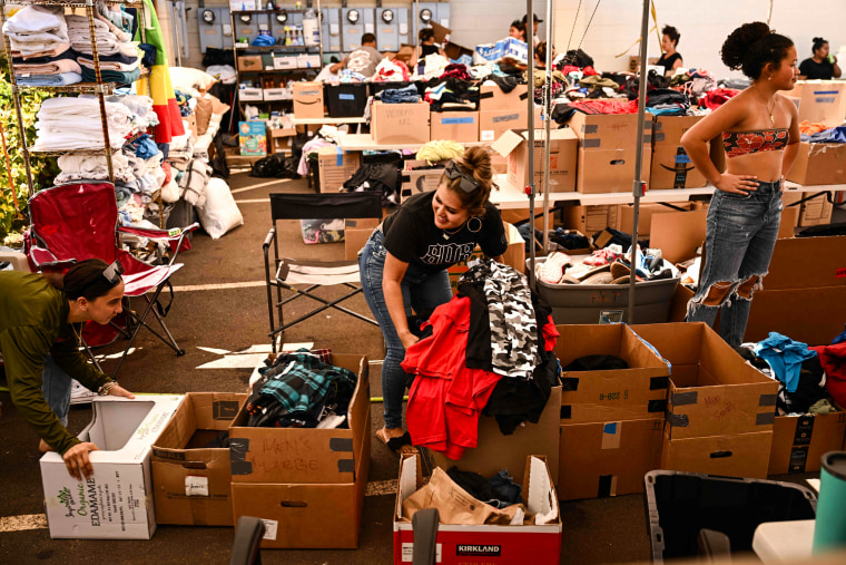 Volunteers sort and organize donated supplies in Wailuku, Hawaii, on Aug. 12, 2023.