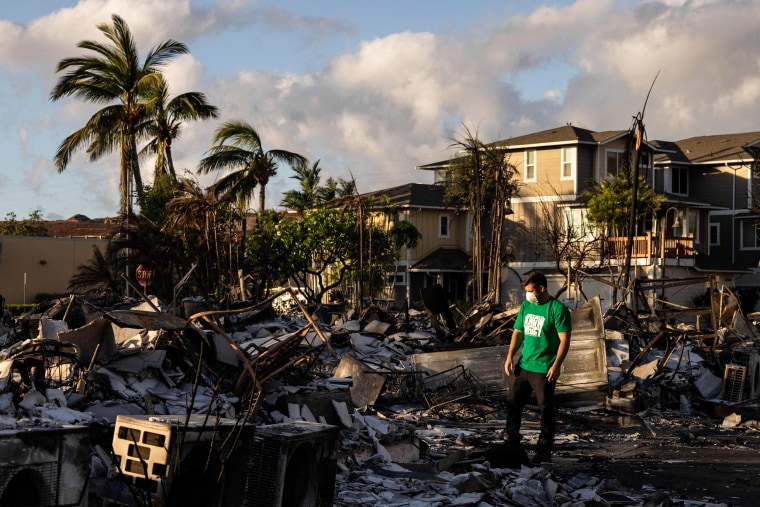 A Mercy Worldwide volunteer assesses the damage at a charred apartment complex in the aftermath of a wildfire in Lahaina, western Maui, Hawaii, on Aug. 12, 2023.