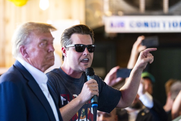 Rep. Matt Gaetz, R-Florida, speaks with 2024 Republican presidential candidate Donald Trump, left, at the Steer N' Stein bar while attending the Iowa State Fair Saturday, Aug. 12, in Des Moines, Iowa. 2023. Republican presidential candidates are gathering in Des Moines this weekend, hoping to make an impression voters will remember coming to the party's Jan. 15 caucuses.