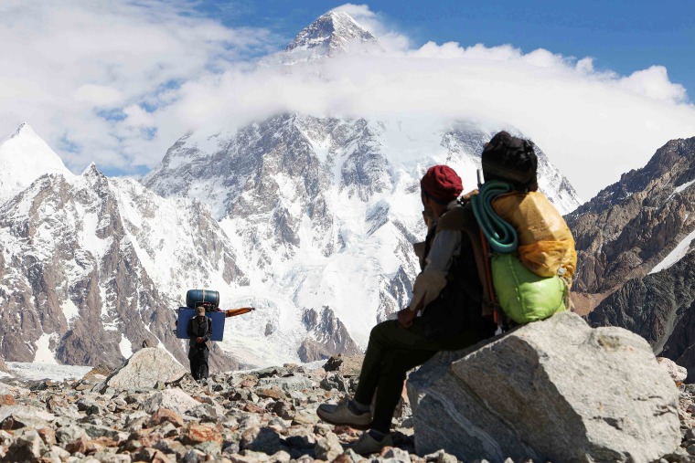 Under mountains that dagger the sky, a misfit caravan of Pakistani porters trudge towards K2 toting live chickens and lawn furniture for adventurers seeking an audience with the world's second-highest peak. 
