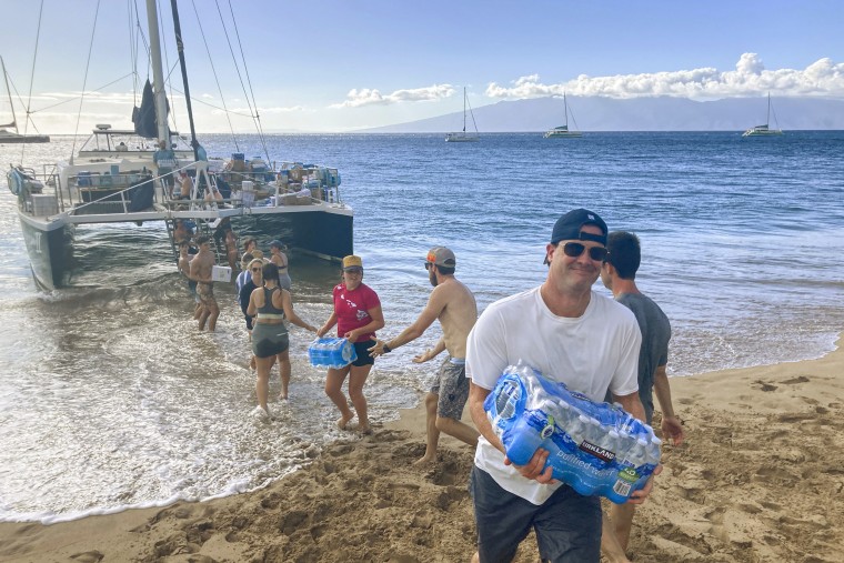 A group of volunteers unload donations in Maui, Hawaii, on Aug. 12, 2023.