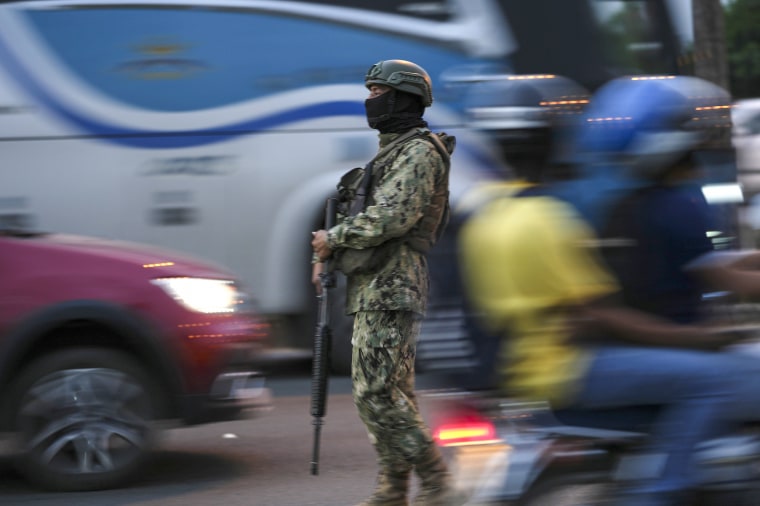 A soldier monitors vehicle traffic on the bridge that connects the town of Duran with Guayaquil, Ecuador, on July 20, 2023.