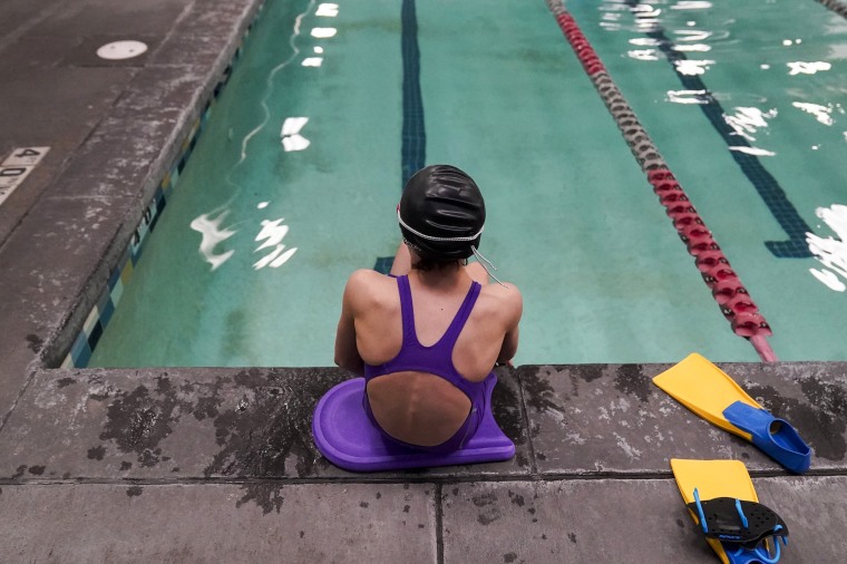 A 12-year-old trans swimmer waits by a pool in Utah on Feb. 22, 2021.