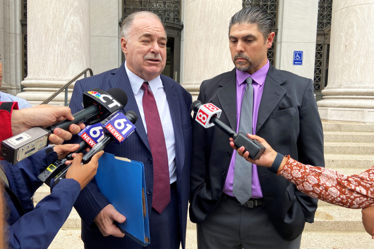 Derby, CT alderman and mayoral candidate Gino DiGiovanni, Jr.  and his attorney Martin Minnella appear outside New Haven federal court after DiGiovanni Jr.’s first appearance before a judge in connection with his Tuesday arrest on January 6th charges.” height=