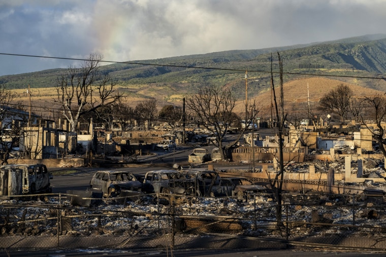 LAHAINA, HI - AUGUST 13:
A rainbow is seen from Put Kukui mountain over burned cars and buildings in Lahaina, Hawaii on Aug. 13, 2023.