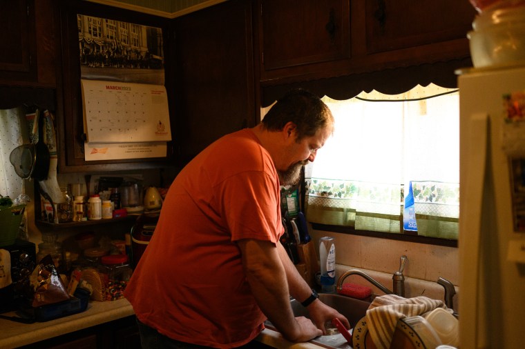  Steve Roberts Jr., pours a glass of water to check its clarity on March 29, 2023 in New Freeport, Pa. 