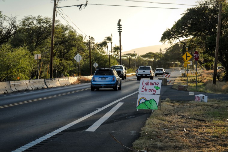 Cars drive by a “Lahaina strong” sign on Honoapiilani Highway, heading into Lahaina, Maui, Hawaii, on Aug. 16, 2023