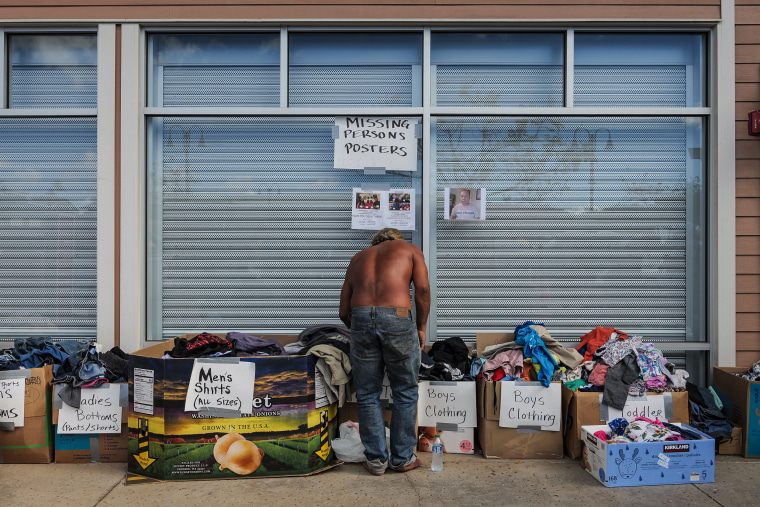 A man looks through clothing at a donation site in Lahaina, Maui, Hawaii on Aug. 16, 2023.