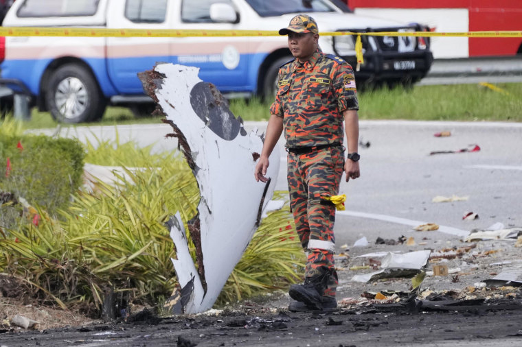 Police say a small aircraft has crashed in the suburb of Malaysia's central Selangor state, with multiple bodies recovered. (AP Photo/Vincent Thian)