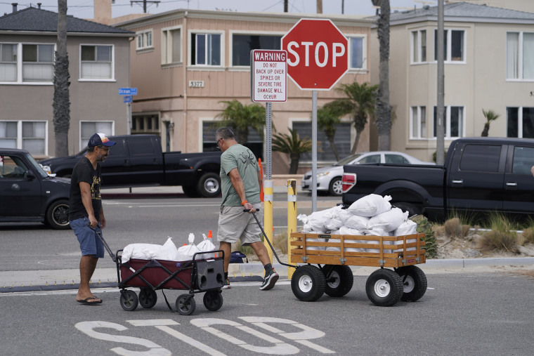 Long Beach residents pull wagons with sandbags ahead of Hurricane Hilary in Long Beach, Calif., Saturday, Aug. 19, 2023. 