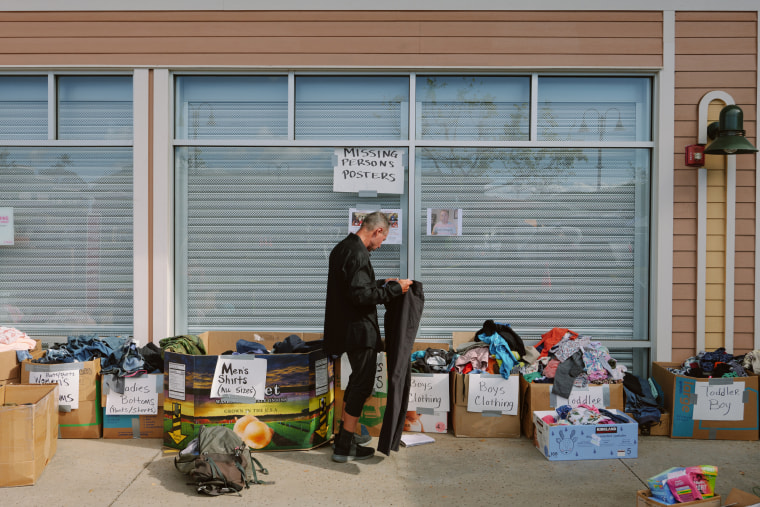 A man looks through clothing at a donation site in Lahaina, Maui, Hawaii on Aug. 16, 2023.