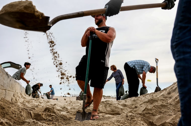 People make sandbags in Seal Beach, Calif., as Hurricane Hilary approaches on Aug. 19, 2023.