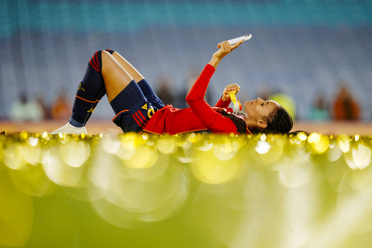 Spain's Salma Paralluelo lies on the ground with her medal at the end of the Women's World Cup in Sydney on Aug. 20, 2023. Spain won 1-0.