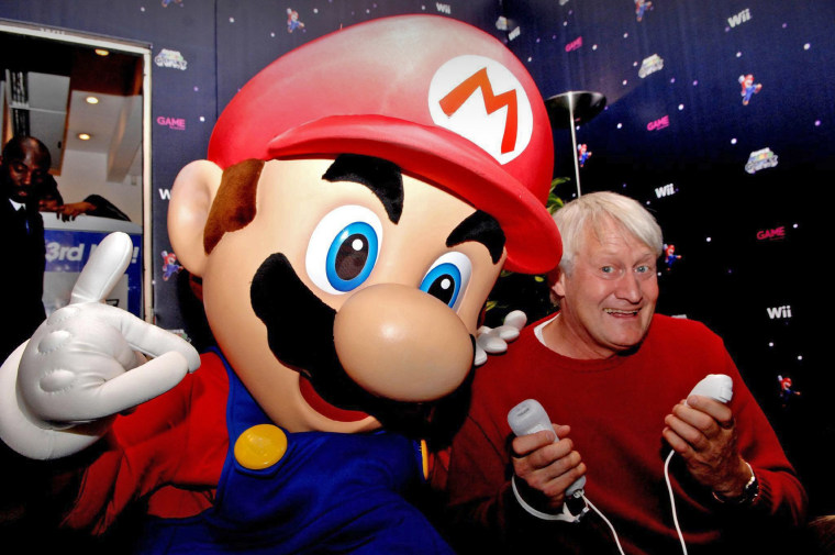 The voice of Super Mario, Charles Martinet, poses with Mario at an event in London in 2007.