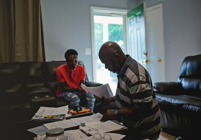 Cory Jones, Sr., looks at some of the paperwork related to his son's in-school suspension in Tuscaloosa, Ala.  
