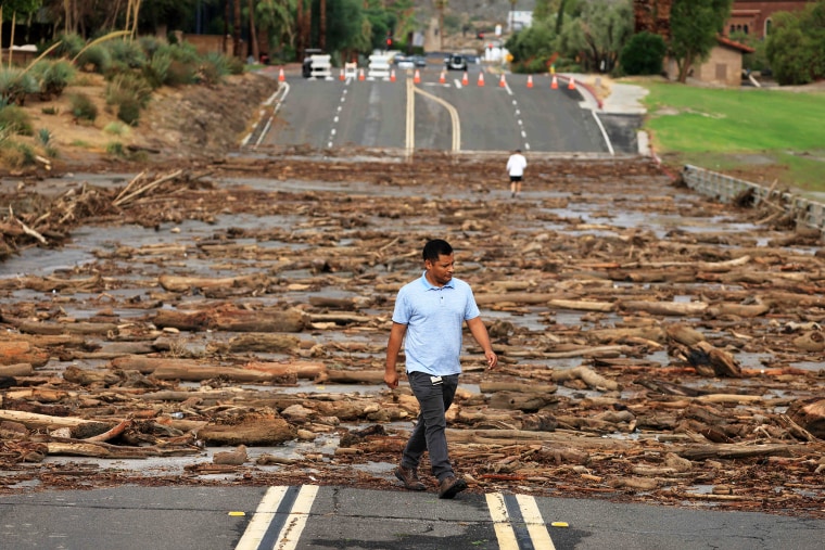 TOPSHOT - A worker from the Coachella Valley Water Department surveys the debris flow following heavy rains from Tropical Storm Hilary, at Thurderbird Country Club in Rancho Mirage, California, on August 21, 2023. Tropical Storm Hilary drenched Southern California with record rainfall, shutting down schools, roads and businesses before edging in on Nevada on August 21, 2023. California Governor Gavin Newsom had declared a state of emergency over much of the typically dry area, where flash flood warnings remained in effect until this morning.