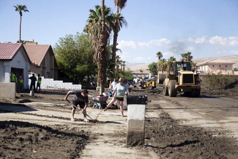 Mud is cleared out of a neighborhood in Cathedral City, Calif., on Tuesday, August 22, 2023.