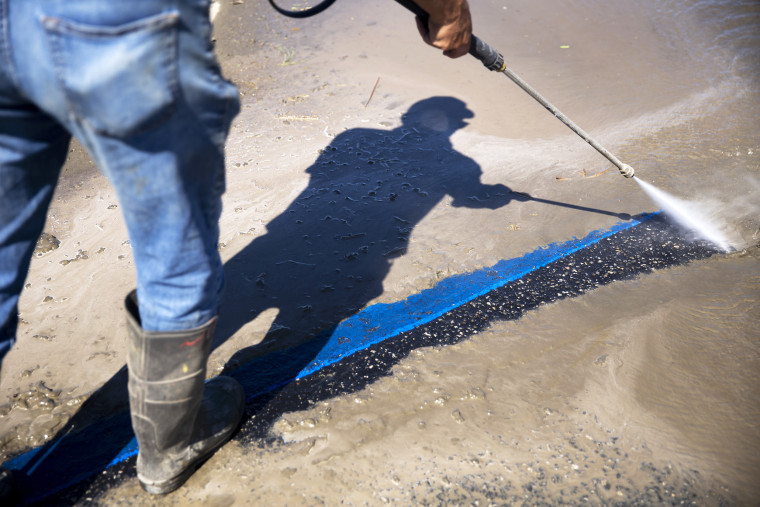 Jose Contreras, 53, power washes the parking lot outside the preschool Mecca Migrant Head Start in Mecca, CA., on Tuesday, August 22, 2023.