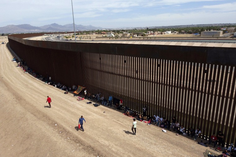 Migrants camp out next to the border barrier between El Paso, Texas and Ciudad Juárez, Mexico, Wednesday, May 3, 2023. The Biden administration has requested 1,500 troops for the U.S.-Mexico border amid an expected migrant surge following the end of pandemic-era restrictions.