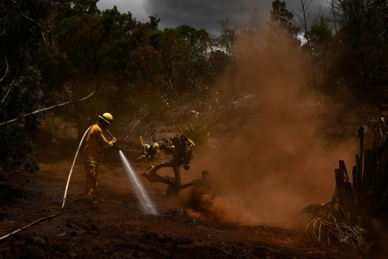 A Maui County firefighter works in Kula, Hawaii, on Aug. 13, 2023.