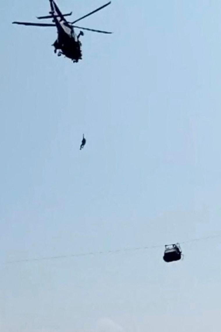 Six children and two adults were suspended inside a cable car dangling over a deep valley in Pakistan for several hours on August 22, as a military helicopter hovered nearby. 